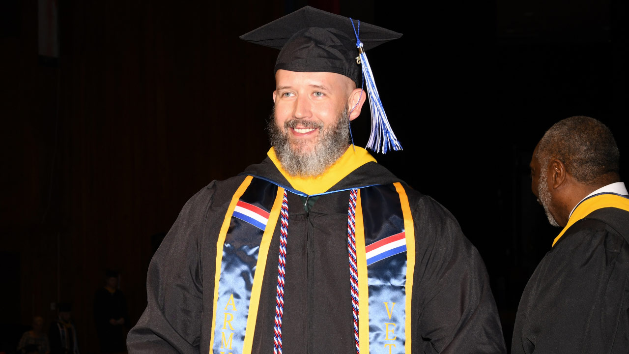 Daniel walking the stage at his graduation ceremony at ECPI University