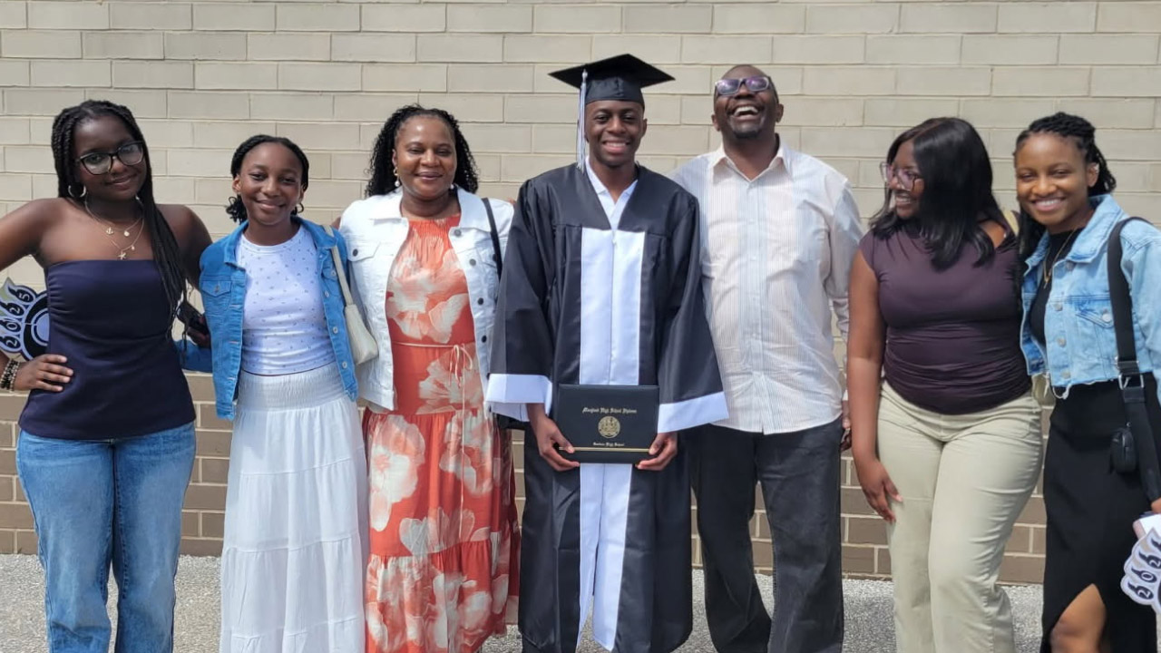 Solomon with his son as they celebrate his first graduation