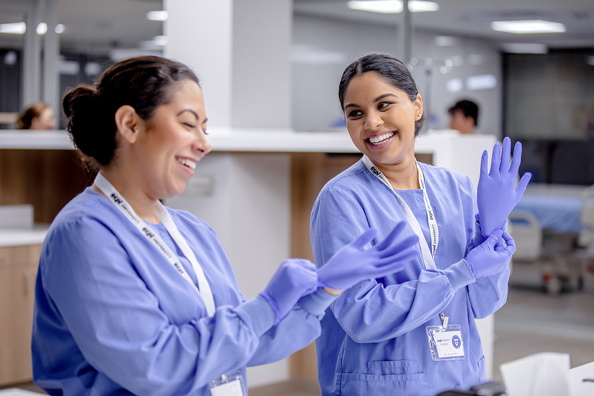 Nursing students in clinical setting smiling