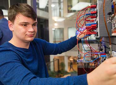 Engineering technology student reviewing technical systems