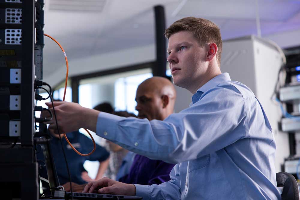 Cybersecurity student working in a technology lab