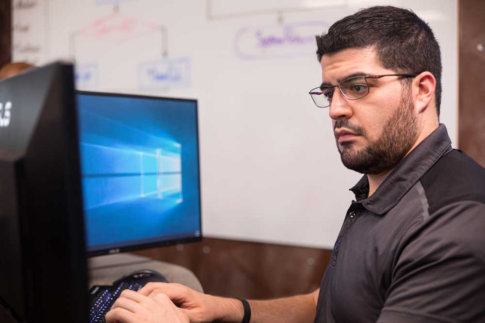 Data analytics student working with technology systems