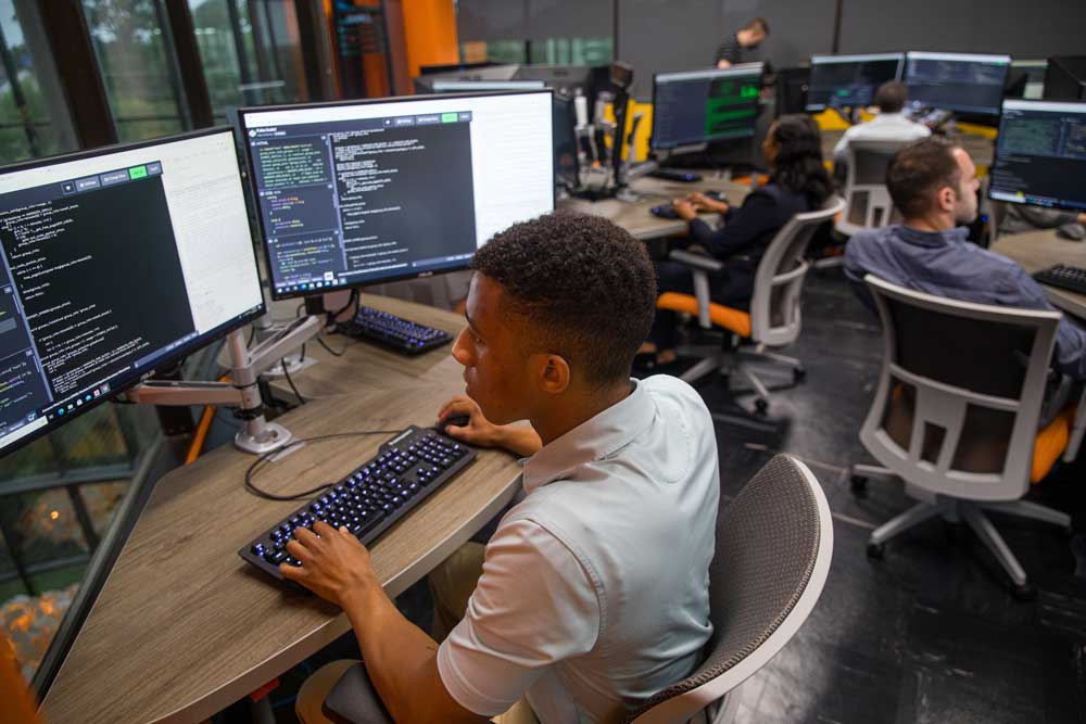 Software development student working in a technology classroom