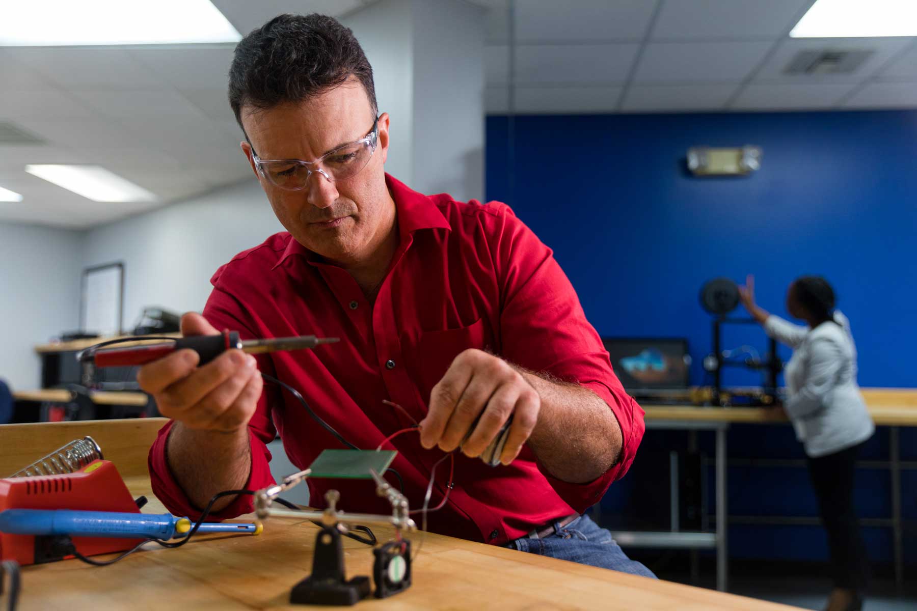Mechanical engineering technology student working with lab equipment