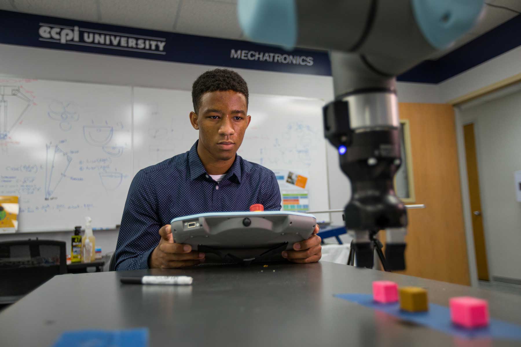 Mechatronics student working with electronics equipment