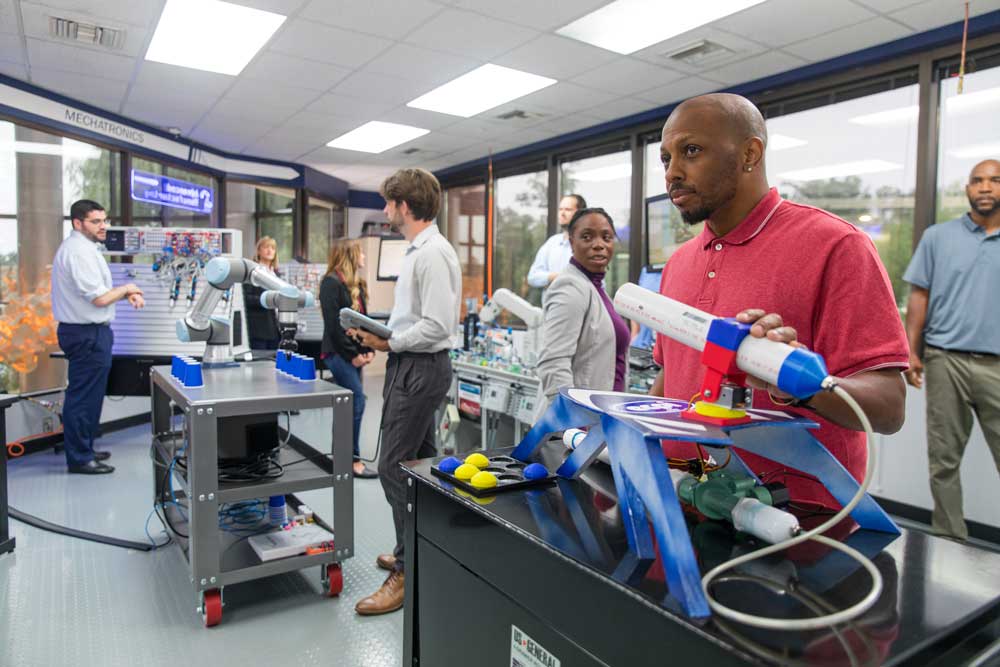 Student working with technology equipment in a lab